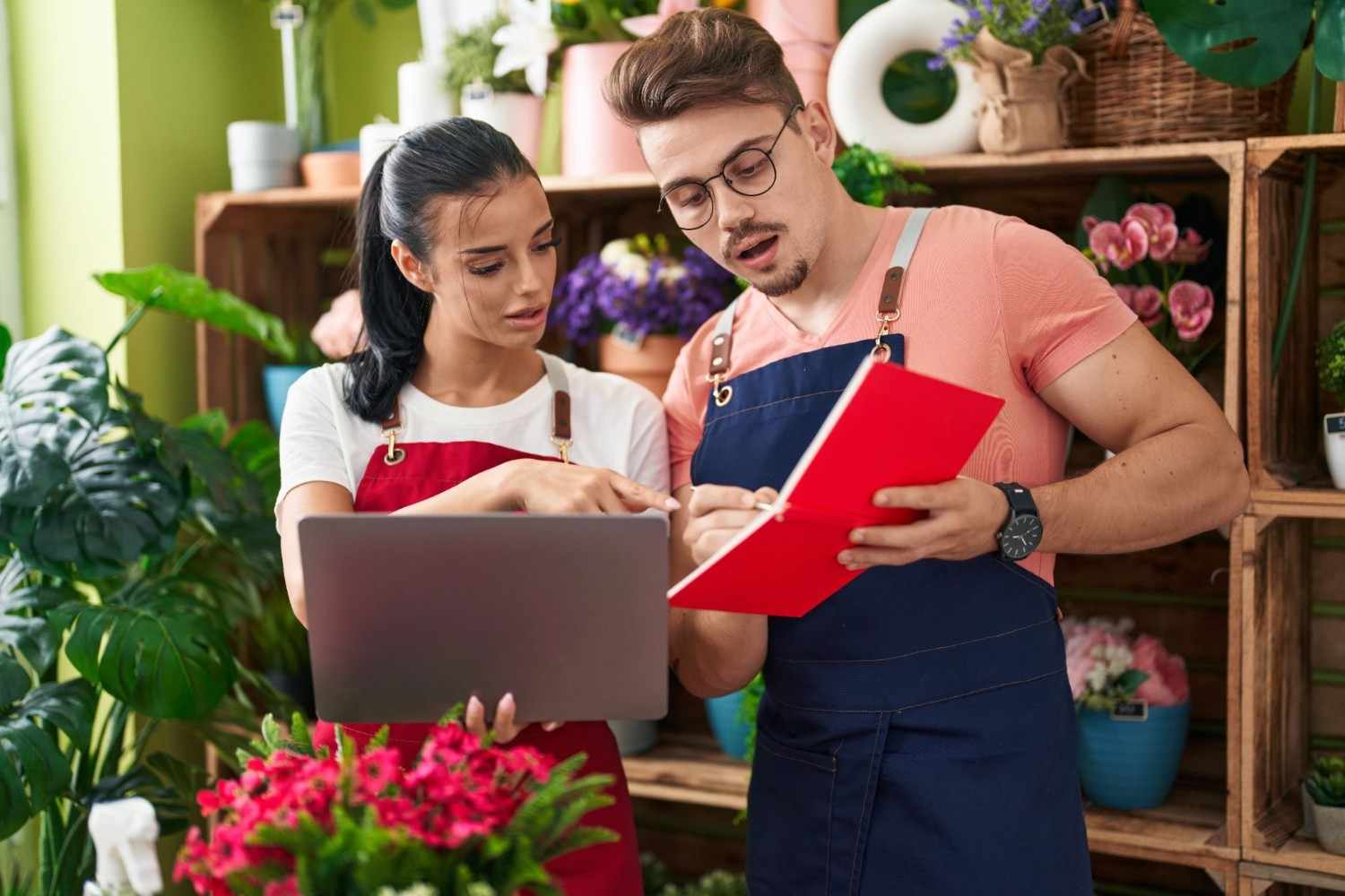 Small business owners planning content marketing strategies in a flower shop