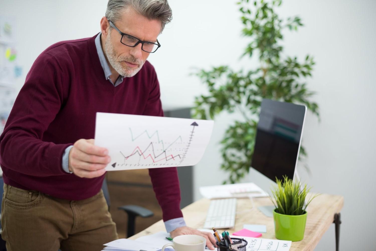 Business owner analyzing marketing ROI and performance charts for campaign results
