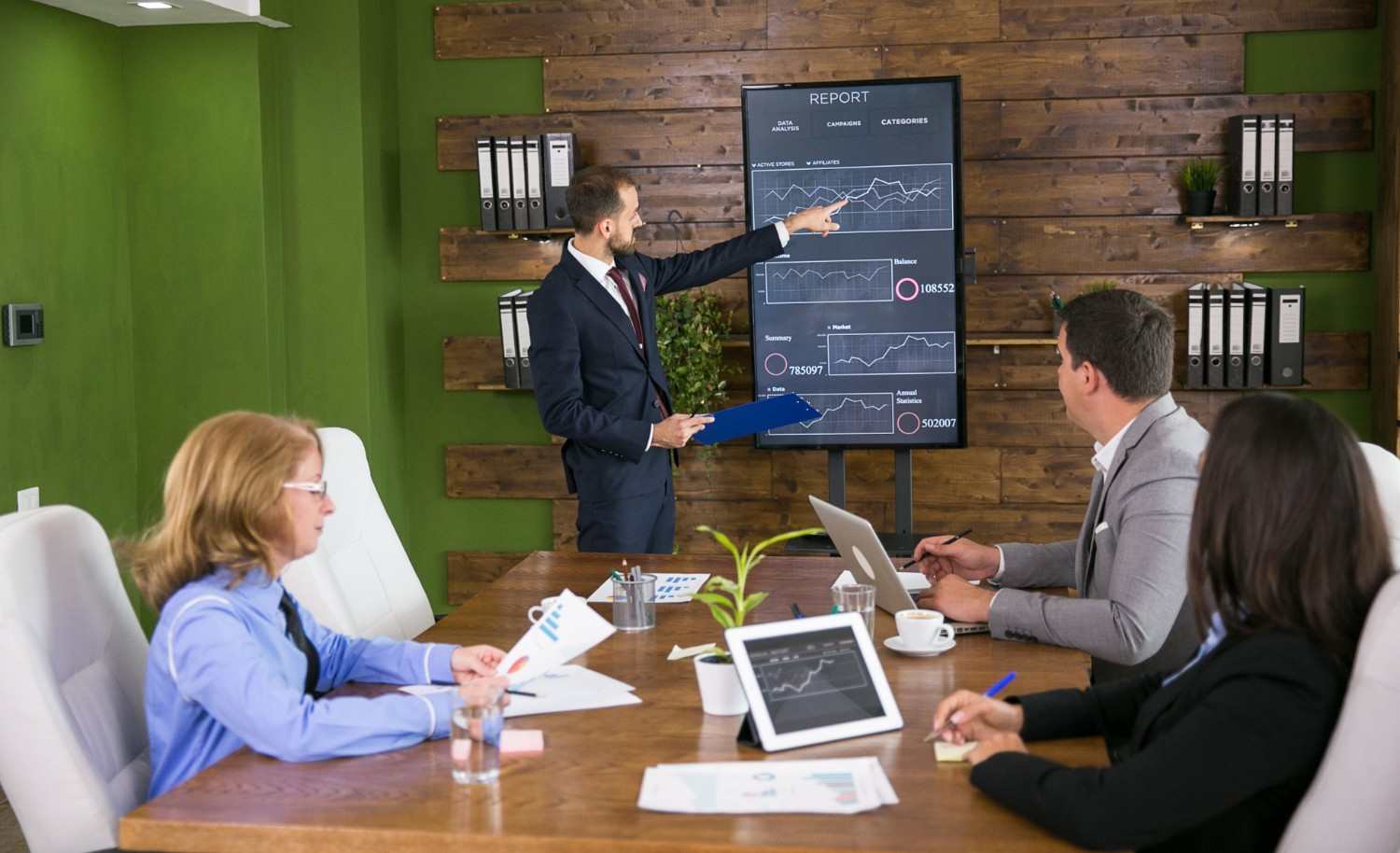 Digital marketing team reviewing SEO performance data and business growth charts