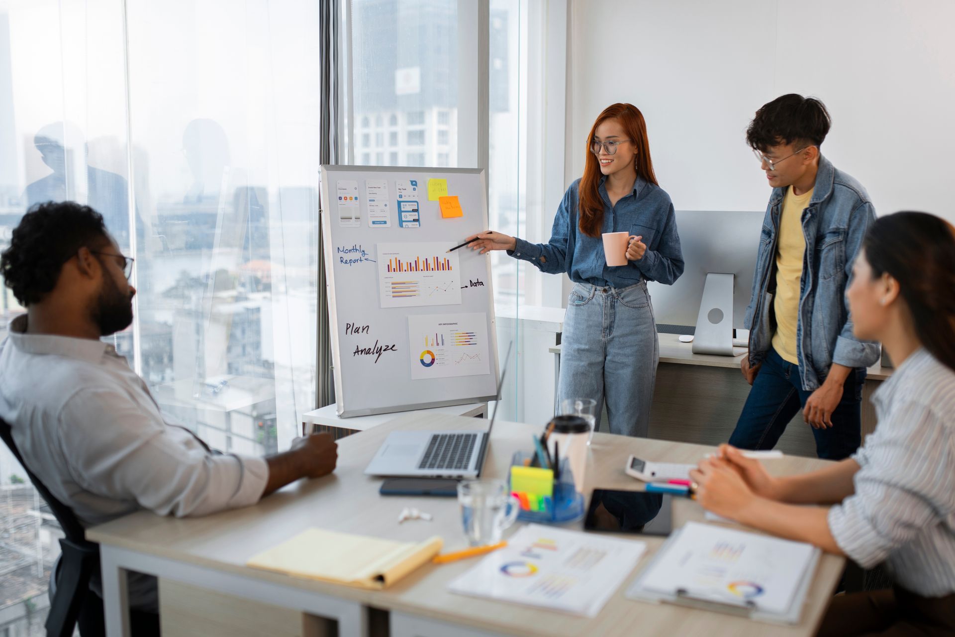 An seo agency team reviewing monthly performance charts and marketing plans in a modern office