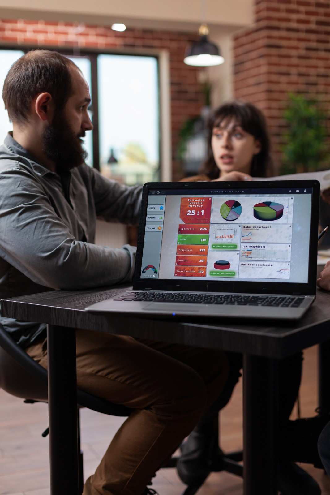 Digital marketing team reviewing analytics dashboard on a laptop.