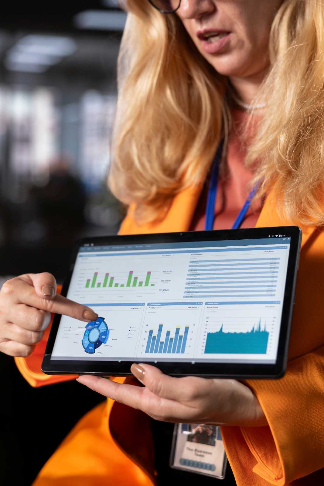Digital marketer analyzing a campaign performance dashboard on a tablet.