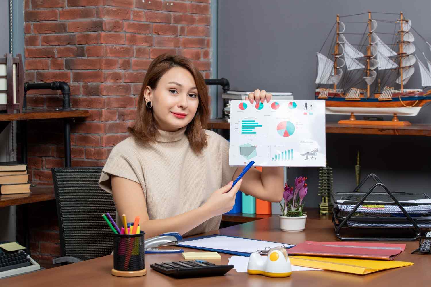 Digital marketer presenting campaign performance graphs at her desk.