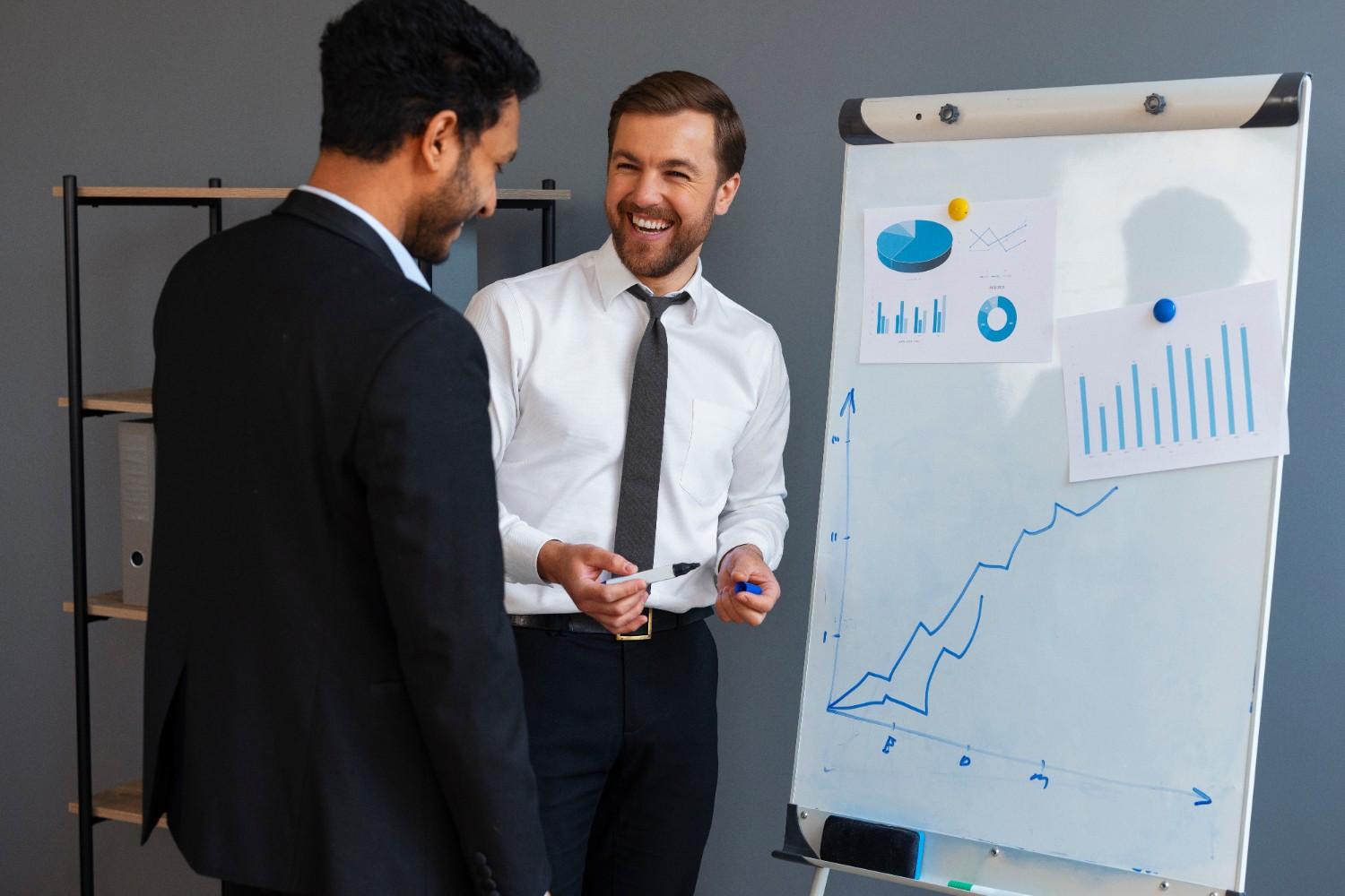 Digital marketing consultants reviewing campaign performance and business growth strategy with analytics charts.