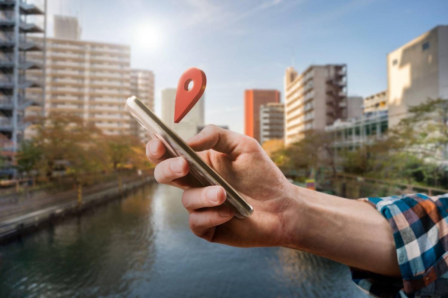 Phone with 3D red location pin showing Google Business Profile visibility in a city.