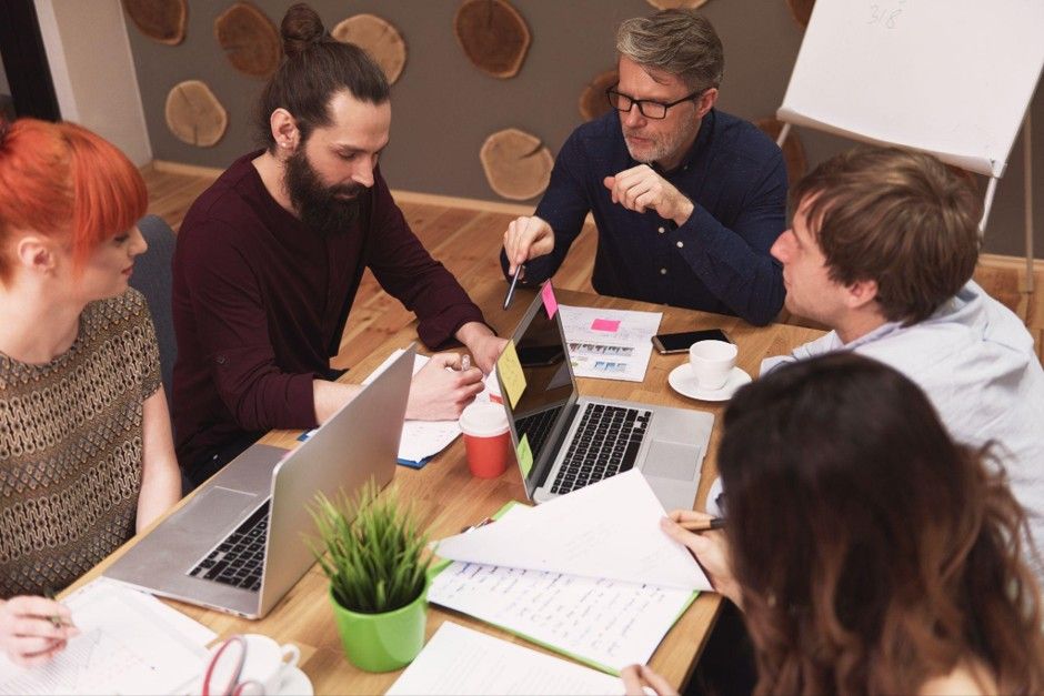 digital marketing agency team analyzing SEO performance charts and data during a strategy meeting.