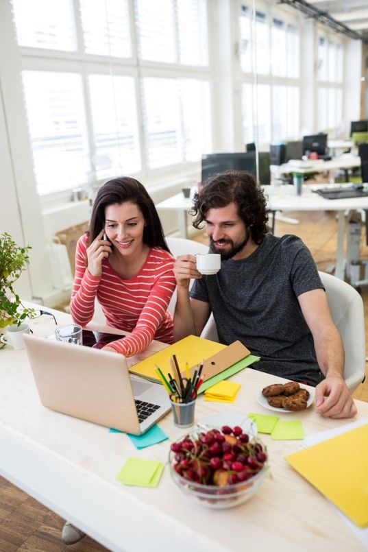digital marketing professionals collaborating on a web development project at an office desk.
