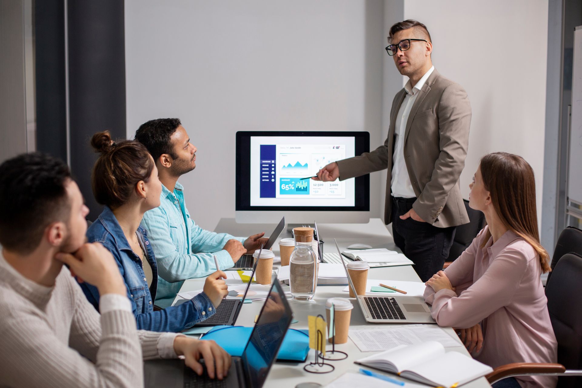 A digital marketing agency team reviewing local SEO and growth analytics during a client strategy meeting.