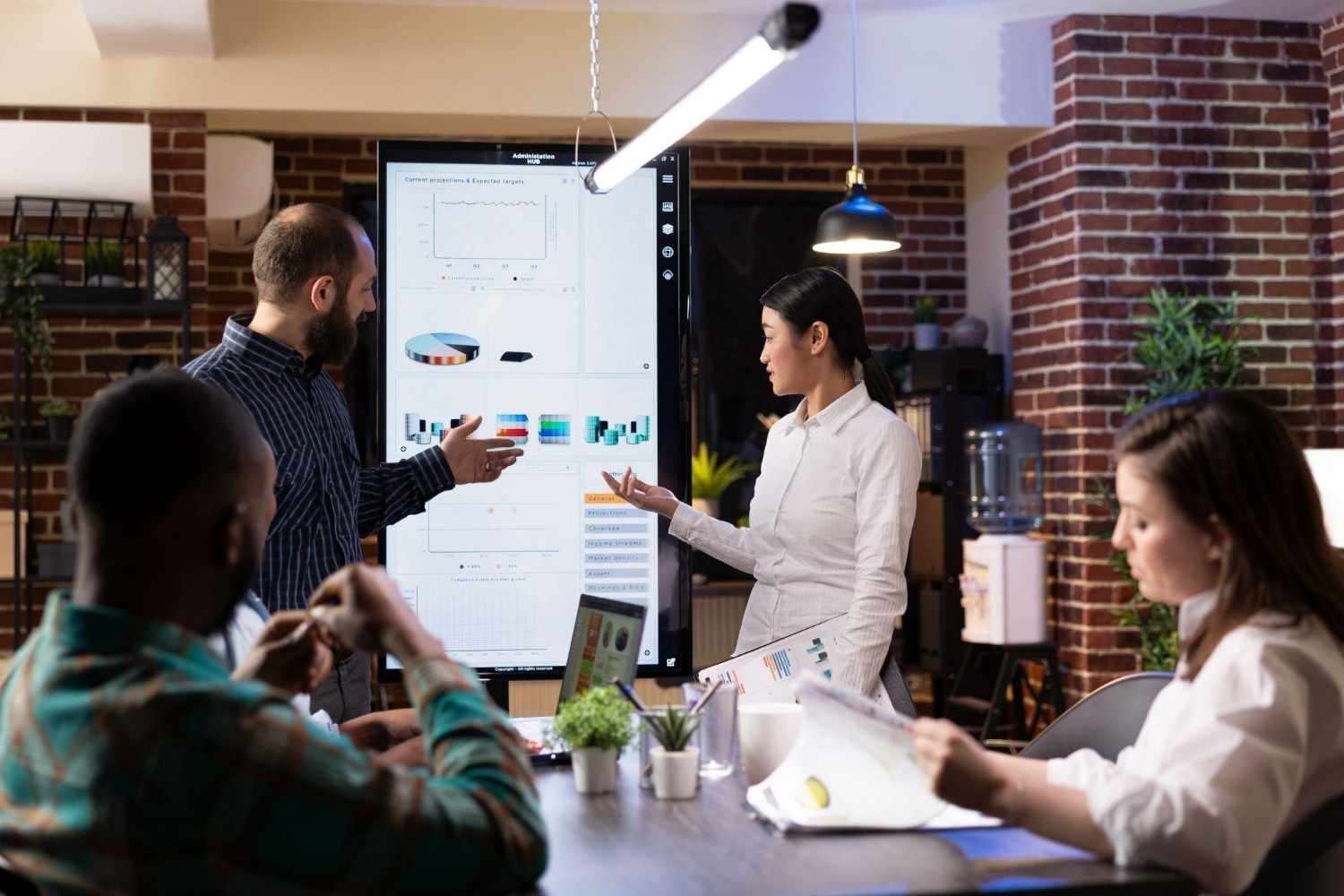 Long Island marketing team analyzing campaign data on a large screen.