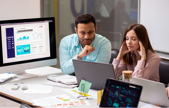 Team reviewing website analytics and performance metrics on desktop screens