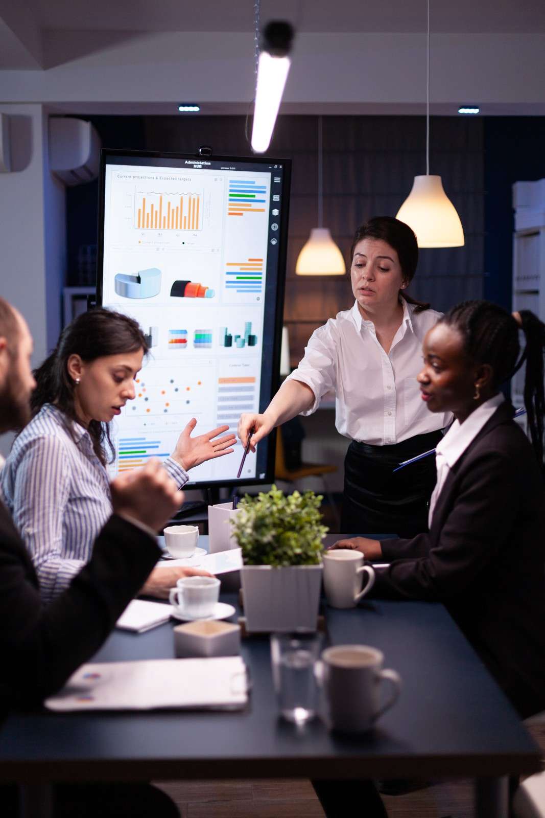 Marketing team discussing digital campaign metrics in a meeting.